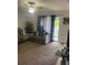 Well-lit living room with neutral walls, ceiling fan, and a sliding glass door to balcony at 3802 Cortez Cir # D, Tampa, FL 33614