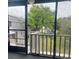 Enclosed balcony boasts an expansive view of lush greenery, offering a tranquil retreat and an abundance of natural light at 3802 Cortez Cir # D, Tampa, FL 33614