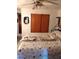 Bedroom features include a ceiling fan, large closet, and comfortable, patterned bedding at 39343/39349 Rusbe, Zephyrhills, FL 33540