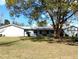 Single-story home with mature trees and a well-maintained lawn at 39343/39349 Rusbe, Zephyrhills, FL 33540
