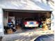 Spacious garage with car parked inside, showing ample storage and organization potential at 39343/39349 Rusbe, Zephyrhills, FL 33540