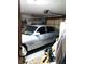 Garage with parked vehicle, storage shelves, and overhead lighting at 39343/39349 Rusbe, Zephyrhills, FL 33540