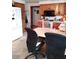Kitchen with black appliances, wood cabinets, and a breakfast bar with chairs at 39343/39349 Rusbe, Zephyrhills, FL 33540