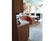 Cozy kitchen with wood cabinets, white countertops, and a small dining area at 39343/39349 Rusbe, Zephyrhills, FL 33540