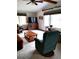 Living room featuring carpet, ceiling fan, TV, and furniture at 39343/39349 Rusbe, Zephyrhills, FL 33540