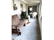 Screened in porch with white ceiling and concrete floor, featuring a wooden bench at 39343/39349 Rusbe, Zephyrhills, FL 33540