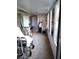 Enclosed sunroom with multiple windows and a variety of furnishings at 39343/39349 Rusbe, Zephyrhills, FL 33540