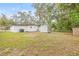 Spacious backyard with shed, and white exterior of the house at 4220 E Regnas Ave, Tampa, FL 33617