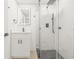 Tastefully renovated bathroom with modern fixtures, sleek vanity, and glass shower with rain shower head at 4220 E Regnas Ave, Tampa, FL 33617