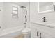 Well-lit renovated bathroom featuring a modern tub/shower combination and sleek vanity at 4220 E Regnas Ave, Tampa, FL 33617