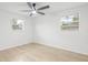 Sun-filled bedroom with large windows and a ceiling fan at 4220 E Regnas Ave, Tampa, FL 33617