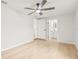 Clean bedroom with a ceiling fan, and adjacent renovated bathroom at 4220 E Regnas Ave, Tampa, FL 33617