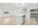 Bright, open kitchen featuring an island, stainless steel appliances, and ample counter space at 4220 E Regnas Ave, Tampa, FL 33617
