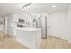 Modern kitchen featuring an island, stainless steel appliances, and bright lighting at 4220 E Regnas Ave, Tampa, FL 33617