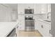 Stylish kitchen with stainless steel appliances, white cabinets, and a modern aesthetic at 4220 E Regnas Ave, Tampa, FL 33617