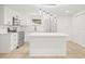 Well-lit kitchen featuring stainless steel appliances, white cabinetry, and an island at 4220 E Regnas Ave, Tampa, FL 33617