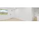 Inviting living room featuring new floors, light-filled windows, and access to other rooms at 4220 E Regnas Ave, Tampa, FL 33617