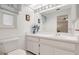 Bathroom featuring a large mirror, white cabinets, and plenty of lighting at 4512 Superior Ln, Clearwater, FL 33762