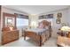 Comfortable bedroom with floral curtains, light-colored carpet, and vintage furniture at 4512 Superior Ln, Clearwater, FL 33762