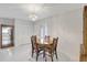 The dining area offers a wood table with seating for four and a decorative chandelier at 4512 Superior Ln, Clearwater, FL 33762