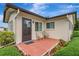 Charming front entrance with a brick-tiled patio, seating, and well-maintained landscaping at 4512 Superior Ln, Clearwater, FL 33762