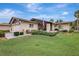 Inviting single-story home featuring a well-manicured lawn, mature landscaping, and charming front porch at 4512 Superior Ln, Clearwater, FL 33762