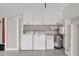 Functional laundry area equipped with a washer, dryer, sink, and built-in storage cabinets at 4512 Superior Ln, Clearwater, FL 33762