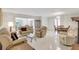 Open living room with tile floors, recessed lighting, and a seamless flow into dining area at 4512 Superior Ln, Clearwater, FL 33762