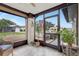 A cozy sunroom features tile flooring, neutral walls, and views of the front yard at 4512 Superior Ln, Clearwater, FL 33762