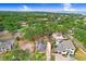 Aerial view of a property with a fenced boundary surrounded by trees, near the water at 4640 W Lamb Ave, Tampa, FL 33629