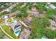 Aerial view of a single-Gathering home in a neighborhood surrounded by lush trees at 4640 W Lamb Ave, Tampa, FL 33629
