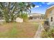Spacious backyard features a shed, mature trees, and privacy fencing at 4640 W Lamb Ave, Tampa, FL 33629
