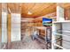 Rustic basement space with wood-paneled walls, mosaic tile floors, and a functional workbench area at 4640 W Lamb Ave, Tampa, FL 33629