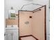 This vintage bathroom features a tiled shower, mirrored vanity, and retro fixtures at 4640 W Lamb Ave, Tampa, FL 33629