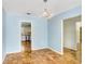 Open dining room featuring parquet floors, blue walls, and a chandelier fixture at 4640 W Lamb Ave, Tampa, FL 33629