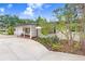 Property features a covered front porch, mature landscaping, and a convenient attached garage at 4640 W Lamb Ave, Tampa, FL 33629