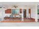 Charming front porch with decorative columns, a brick accent wall, and stylish outdoor seating at 4640 W Lamb Ave, Tampa, FL 33629
