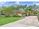 Inviting single-story home features a well-kept lawn, mature landscaping, and a private driveway leading to the garage at 4640 W Lamb Ave, Tampa, FL 33629
