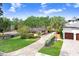 Charming one-story home featuring a well-manicured lawn and long concrete driveway at 4640 W Lamb Ave, Tampa, FL 33629
