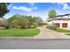 Charming single-Gathering home features a well-manicured front lawn, mature trees, and a long private driveway at 4640 W Lamb Ave, Tampa, FL 33629