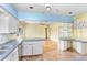Bright eat-in kitchen features tiled floors, white cabinetry, and a breakfast bar area at 4640 W Lamb Ave, Tampa, FL 33629