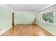 Inviting living room with parquet floors, large window, and classic rocking chair at 4640 W Lamb Ave, Tampa, FL 33629
