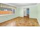 Cozy living room with wood floors, light green walls, and natural light from a window at 4640 W Lamb Ave, Tampa, FL 33629