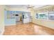 Bright living room with parquet floors, window, and open flow into kitchen at 4640 W Lamb Ave, Tampa, FL 33629