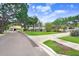 A street view showcases a well-maintained home with a green lawn and mature trees, complemented by neighborhood charm at 4640 W Lamb Ave, Tampa, FL 33629