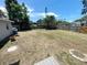Spacious backyard showing the wooden fence, mature trees and views to the neighbors at 4722 Harris Ave, Sarasota, FL 34233