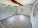 Bright bedroom featuring wainscotting, wood beam, and large windows at 4722 Harris Ave, Sarasota, FL 34233