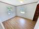 Bedroom with two windows, laminate flooring and a closet at 4722 Harris Ave, Sarasota, FL 34233