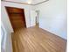 Bedroom featuring neutral walls, light wood-look flooring, and a wood-trimmed closet at 4722 Harris Ave, Sarasota, FL 34233