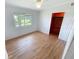 Bedroom featuring wood paneling, laminate flooring and closet at 4722 Harris Ave, Sarasota, FL 34233